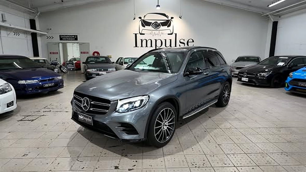 Front view of a grey Mercedes-Benz on the showroom floor